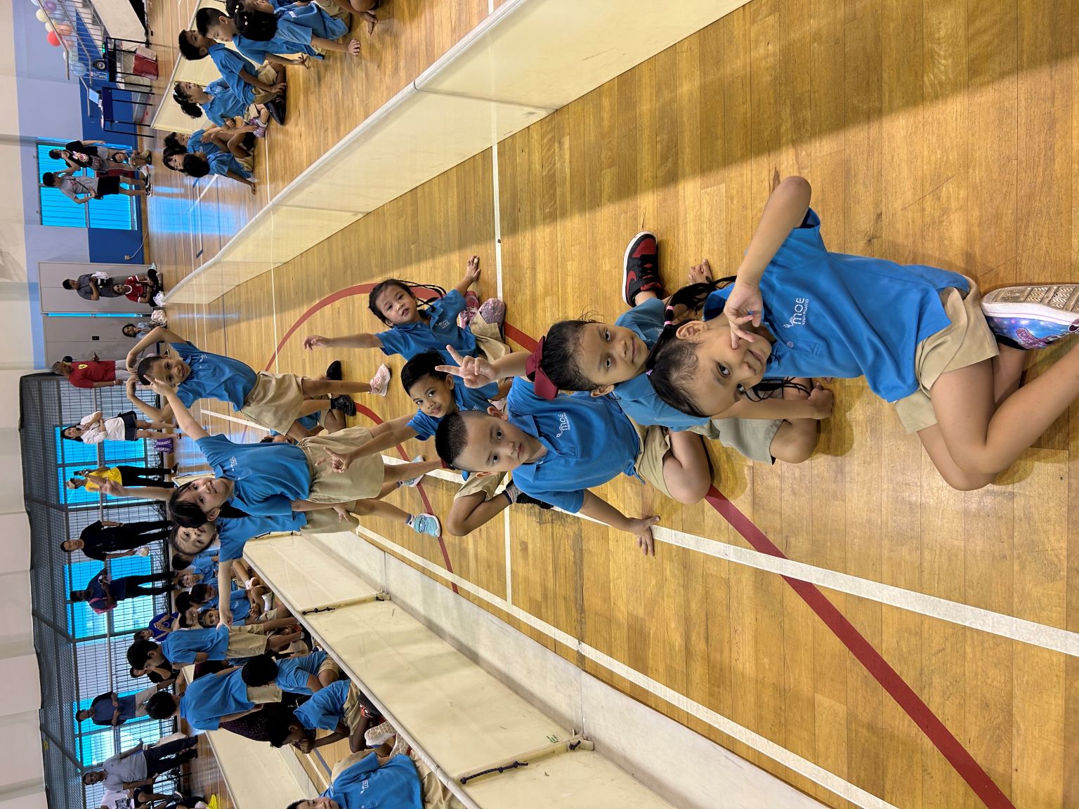 Children enjoying themselves and waiting to do their class cheer!